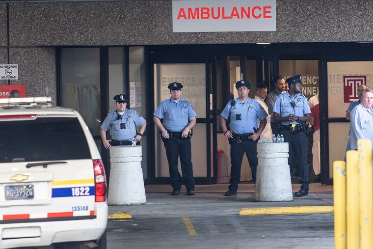 Philadelphia Police official gathered at the Emergency entrance of Temple University Hospital after a multiple police shooting in North Philadelphia.
