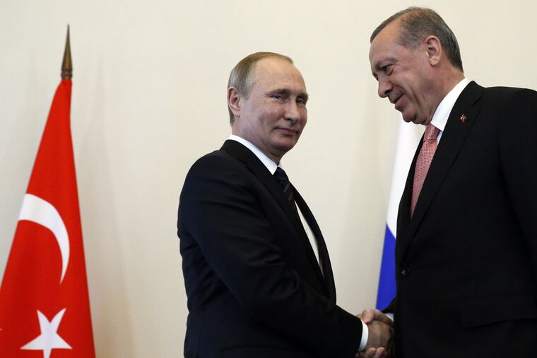 Russian President Vladimir Putin, left, welcomes Turkish President Recep Tayyip Erdogan in the Konstantin palace outside St.Petersburg, Russia, on Tuesday, Aug. 9, 2016.