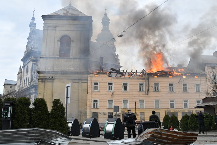 Fire and smoke raises above the city center following Russia's drone attack in Lviv, Ukraine, Tuesday, March 24, 2026.