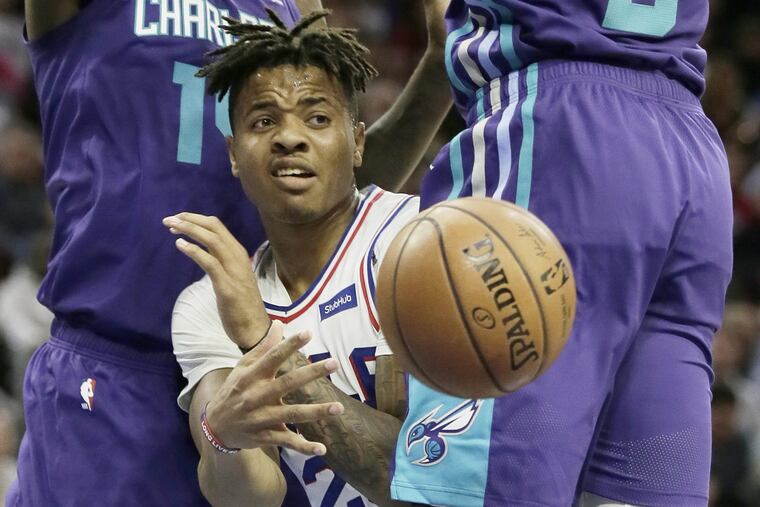 Markelle Fultz splits between the Hornets' Michael Kidd-Gilchrist and Bismack Biyombo to pass during the Sixers' win on Saturday.