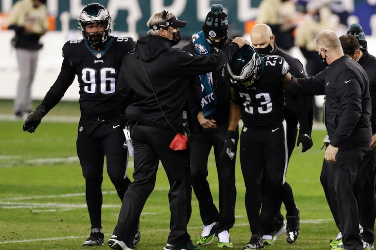 Doug Pederson consoles Rodney McLeod, who leaves the field Sunday, limping heavily.