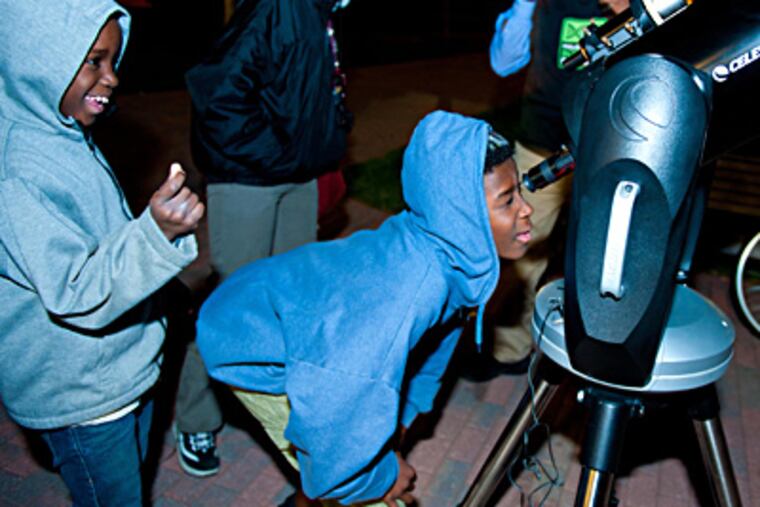 Attendees gaze through a telescope during astronomy night at last year's Philadelphia Science Festival.