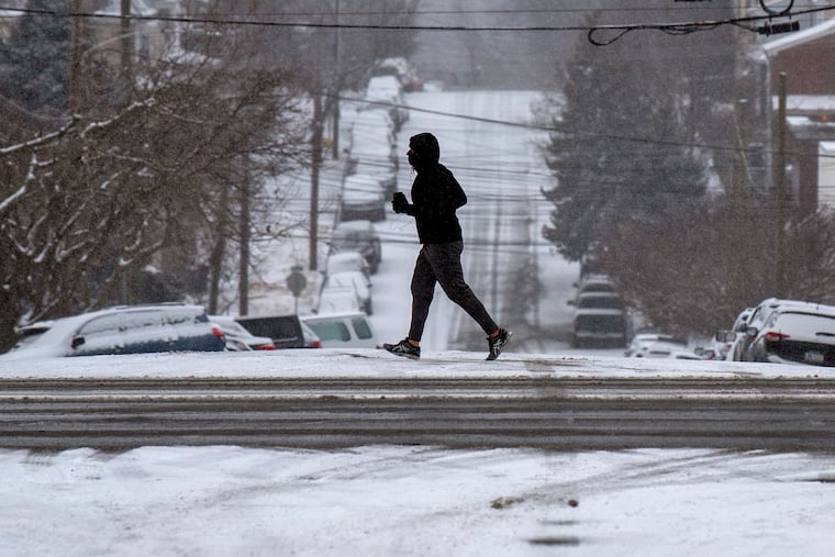 Snow sticks to the street surfaces along Fayette Street in Conshohocken Sunday night as a nor'easter bears down on the region, promising the most significant snowfall in 5 years.