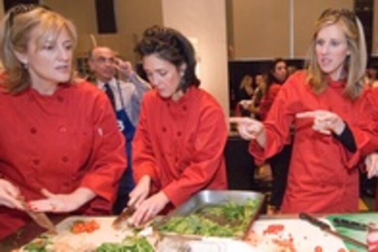 Teammates getting their meal ready are, from left: Kim Cilio, Susan Lipson of Philadelphia Magazine, Barbara Barnhart, Jull Dorvsik, Project H.O.M.E. supporters.