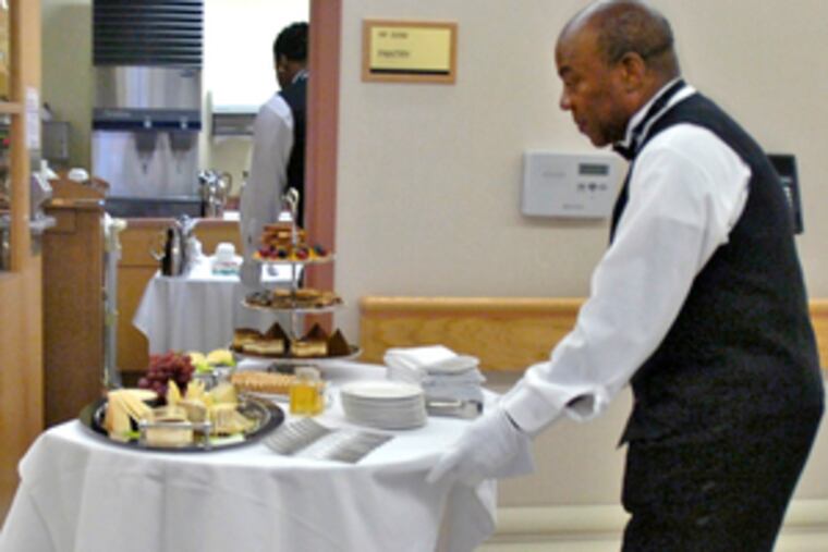 Andrew Emenimadu, full-service manager, delivers high tea in the hospital's Pavilion wing.
