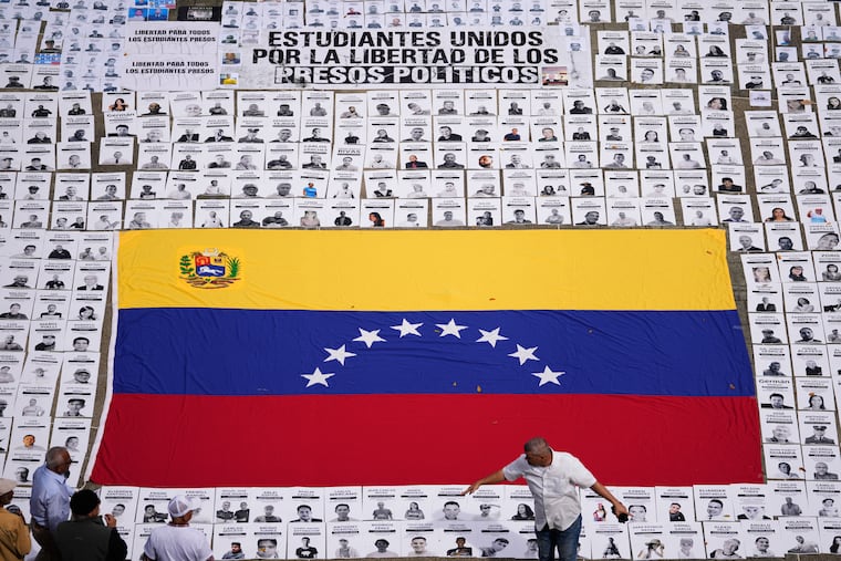 Students lay out photos of people they consider political prisoners at the Central University of Venezuela in the capital city of Caracas.