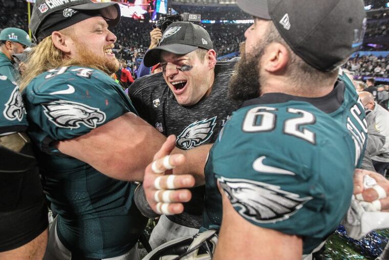 Eagles Beau Allen (left), Brent Celek (center) and Jason Kelce soak up that winning feeling on the field in Minneapolis.