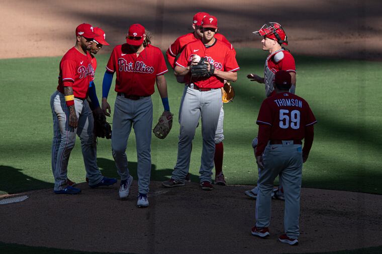 The Phillies gather around Aaron Nola before he exits mound during the fifth inning of Game 2.