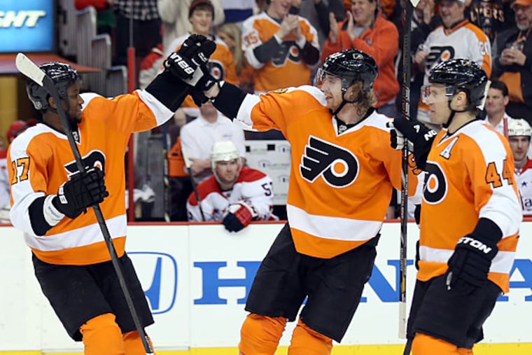 Jakub Voracek (center) celebrates his goal with teammates Wayne Simmonds (left) and Kimmo Timonen against the Capitals. (Yong Kim/Staff Photographer)