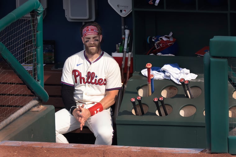 Bryce Harper sits in the dugout earlier this June.