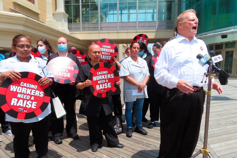 Bob McDevitt, right, president of Local 54 of the Unite Here union, speaks at a press conference on the Atlantic City, N.J., Boardwalk.