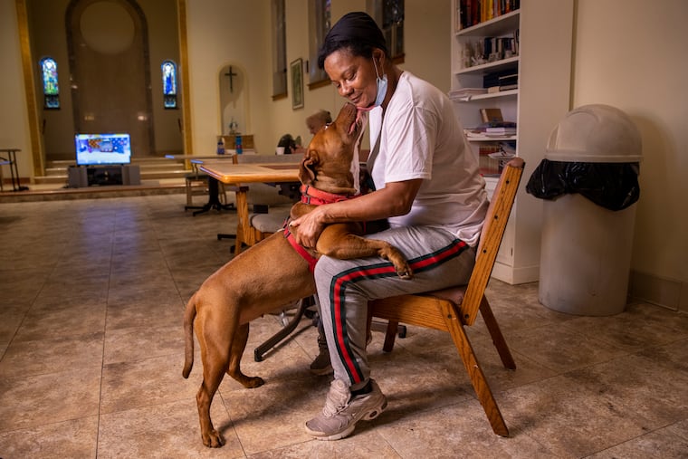 Samantha House with 'Butter Bean,' the 3-year-old Red Nose Pit Bull she raised from a puppy. Originally from West Philadelphia, House and her dog were experiencing homelessness before they came to Project HOME's Sacred Heart Recovery Residence in Hunting Park about six months ago. Sacred Heart is one of two Project HOME facilities that take people with pets.