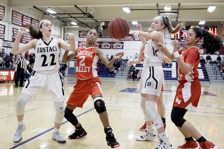 Kylie Bradford (2) and Adriana Agosto (11), pictured battling for a loose ball against Bishop Eustace back on Feb. 15, helped Rancocas Valley defeat Clearview Monday in the opening round of South Group 4 girls' basketball tournament.