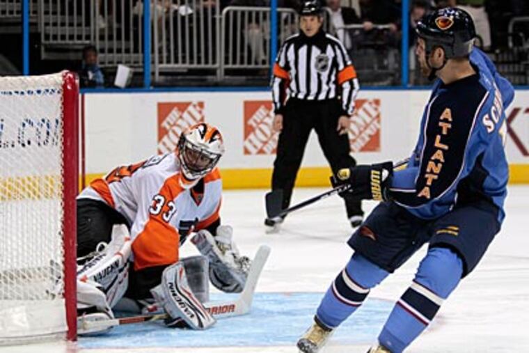Thrashers center Rob Schremp scores on Flyers goalie Brian Boucher during a shootout. (John Bazemore/AP Photo)