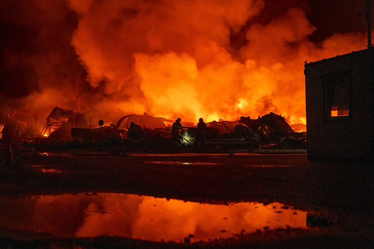 Firefighters put out a fire after Russian missiles hit a warehouse in Kyiv, Ukraine, Wednesday, Aug. 5, 2026.