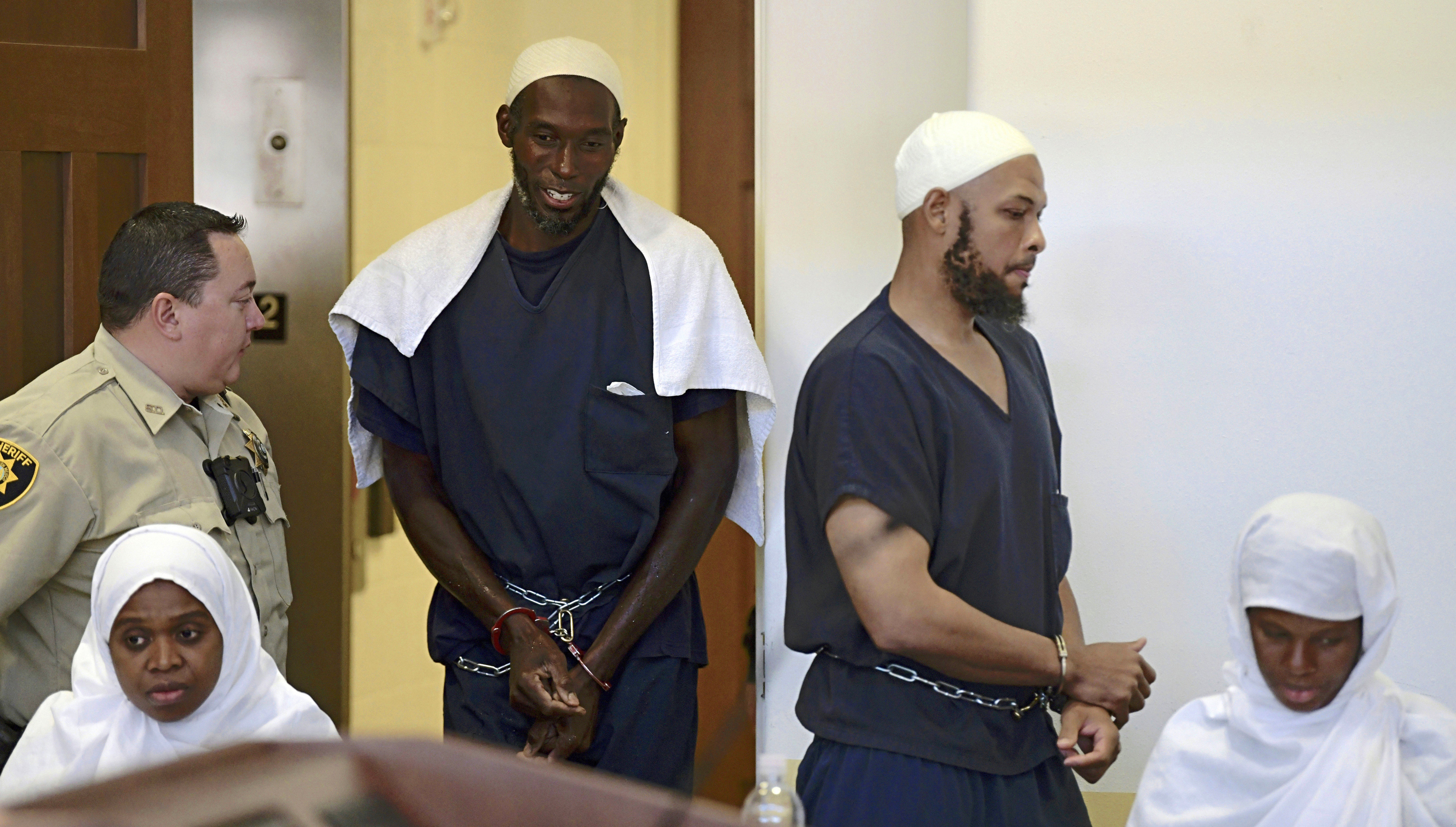 FILE - This Aug. 13, 2018, pool file photo shows defendants (from left) Jany Leveille, Lucas Morton, Siraj Ibn Wahhaj, and Subbannah Wahhaj entering district court in Taos, N.M. U.S. prosecutors will not seek the death penalty against the four adults who lived at a New Mexico compound where authorities found the remains of a toddler who was reported missing in Georgia, court documents say. (Roberto E. Rosales / Albuquerque Journal via AP, Pool, File)