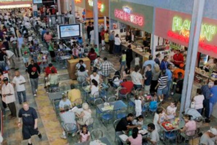 Visitors help celebrate the opening of the International Food Court at the Grand Marketplace in Willingboro.