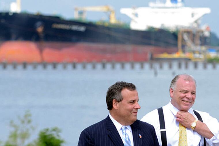On the site of a former tank farm in Paulsboro Monday, July 14, 2014, Gov. Christie (left) and Senate President Stephen Sweeney speak about the Holtec deal in Camden, which leads to a new marine terminal in Paulsboro finally being completed. TOM GRALISH / Staff Photographer