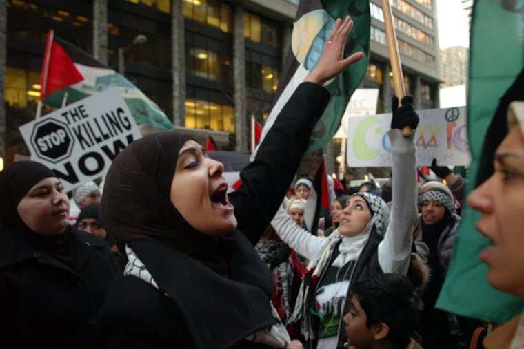 Demonstrators shout pro-Palestinian slogans yesterday outside the Israeli Consulate in the 1800 block of JFK Boulevard.