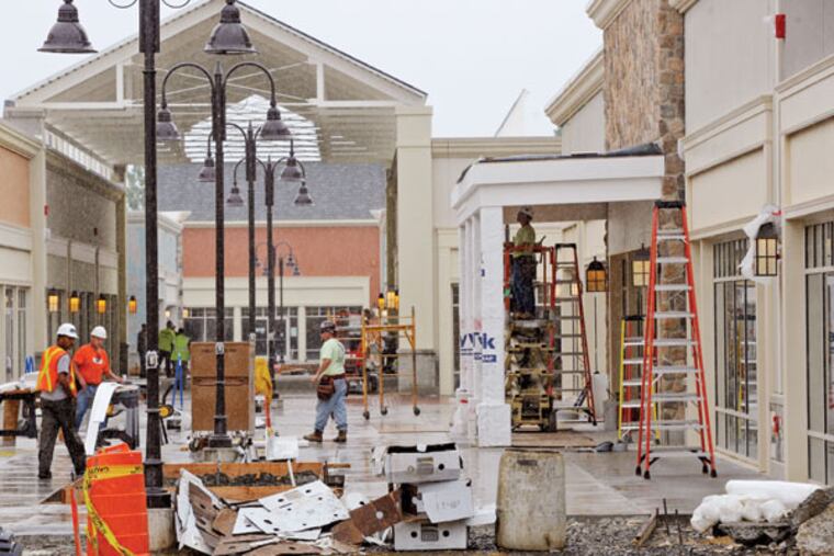 Workers in a walkway at Gloucester Premium Outlets at Gloucester Township. (MICHAEL
PRONZATO / Staff Photographer)