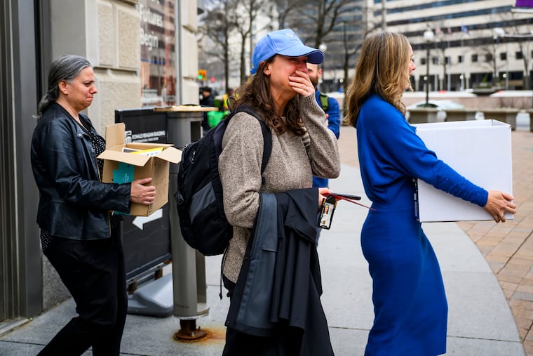 Former USAID employees become emotional as they leave the agency’s former offices at the Ronald Reagan Building and International Trade Center on Feb. 27 in Washington, D.C.