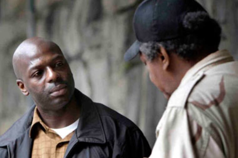 Fred Johnson (left), speaks with a Vietnam vet. After returning from Iraq, Johnson became an addict. (David Maialetti / Staff)