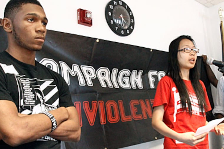 Among those urging restored funding are (from left) Khairi Mace of Ben Franklin High, and Trang Dang of South Philadelphia High. (Elizabeth Robertson / Staff Photographer)