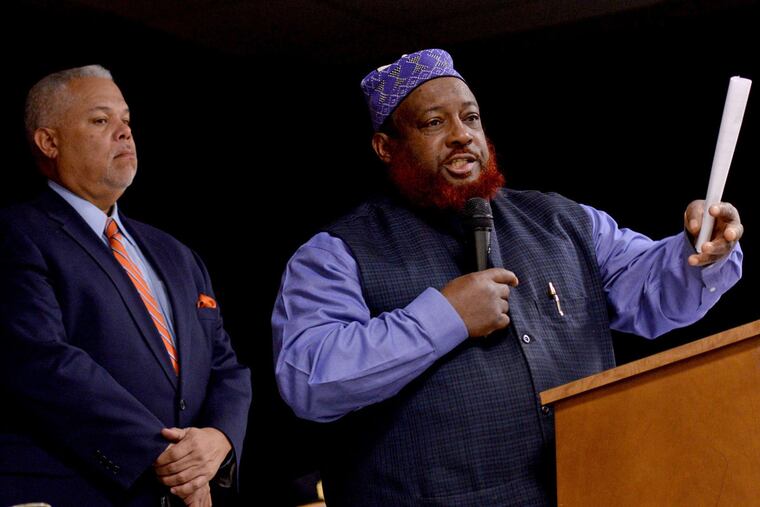 "If you talk about terrorism, I'm terrorized every time I walk out of my house," said Imam Asim Abdur-Rashid. State Sen. Anthony H. Williams listens.