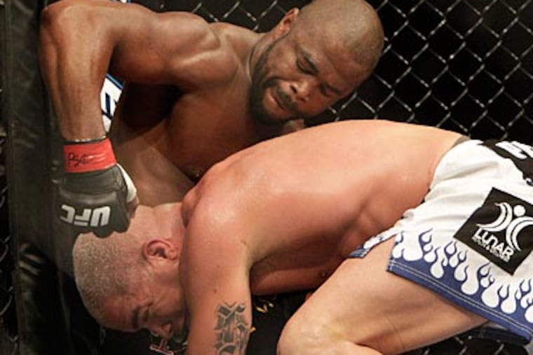 Rashad Evans (top) defeated Tito Ortiz in the main event of UFC 133 at the Wells Fargo Center. (David Maialetti/Staff Photographer)