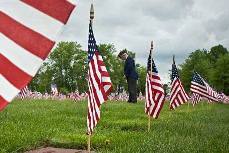John Hood, honorary commander for Joint Base McGuire-Dix-Lakehurst, has a moment of silence for those burried at at Brig. Gen. William C. Doyle Veterans Memorial Cemetery in Arneytown NJ before the annual State of New Jersey Memorial Day commemoration cermony. ( RON TARVER / Staff Photographer ) May 24 2014