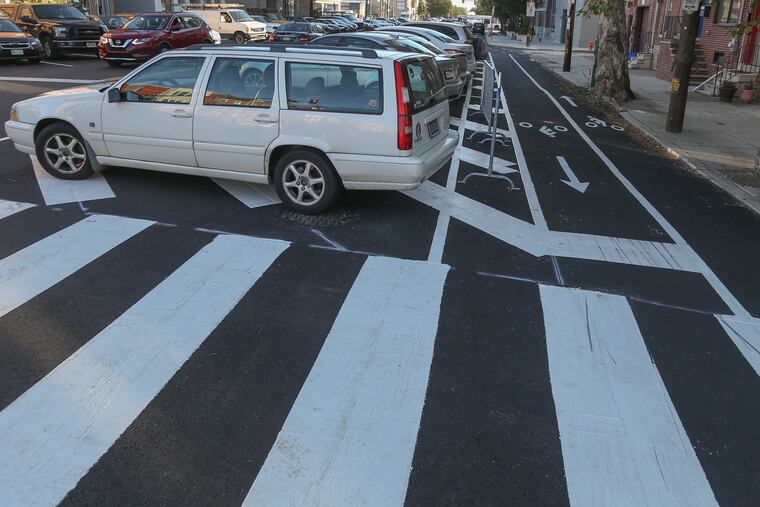 People are parking in no parking zones on 11th and Carpenter Streets in Philadelphia, hurting visibility at intersections and increasing the risk of accidents.