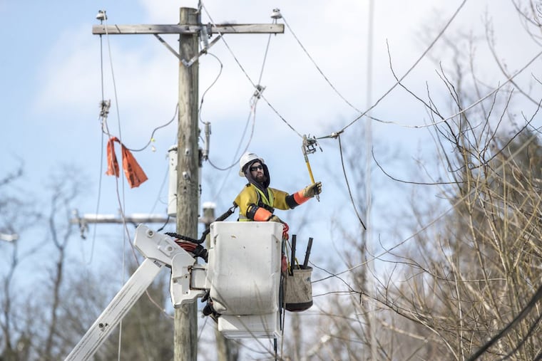 An electrician works on a Peco power line during a storm-related outage in this 2019 file photo.