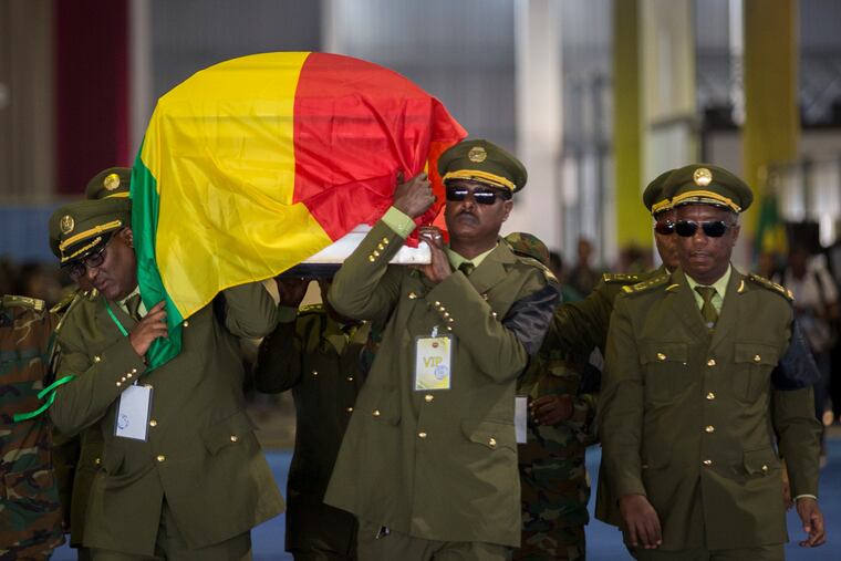 The coffin of assassinated army chief Gen. Seare Mekonnen is taken away for burial after a state ceremony at the Millennium Hall in the capital Addis Ababa, Ethiopia Tuesday, June 25, 2019. Ethiopia's Prime Minister Abiy Ahmed sobbed openly at the service Tuesday for the military chief who was assassinated by his own bodyguard over the weekend. (AP Photo/Mulugeta Ayene)