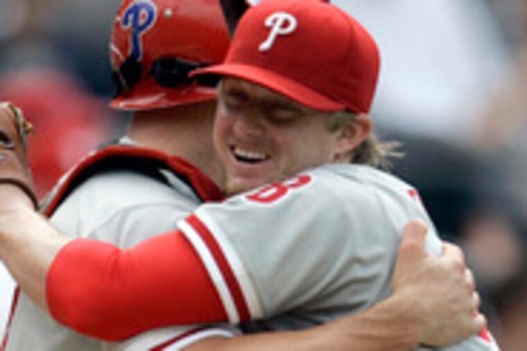 Phillies pitcher J.D. Durbin (right) hugs catcher Chris Coste after the final out of his 5-hit shutout. Durbin bested the Padres' Jake Peavy with plenty of run support.