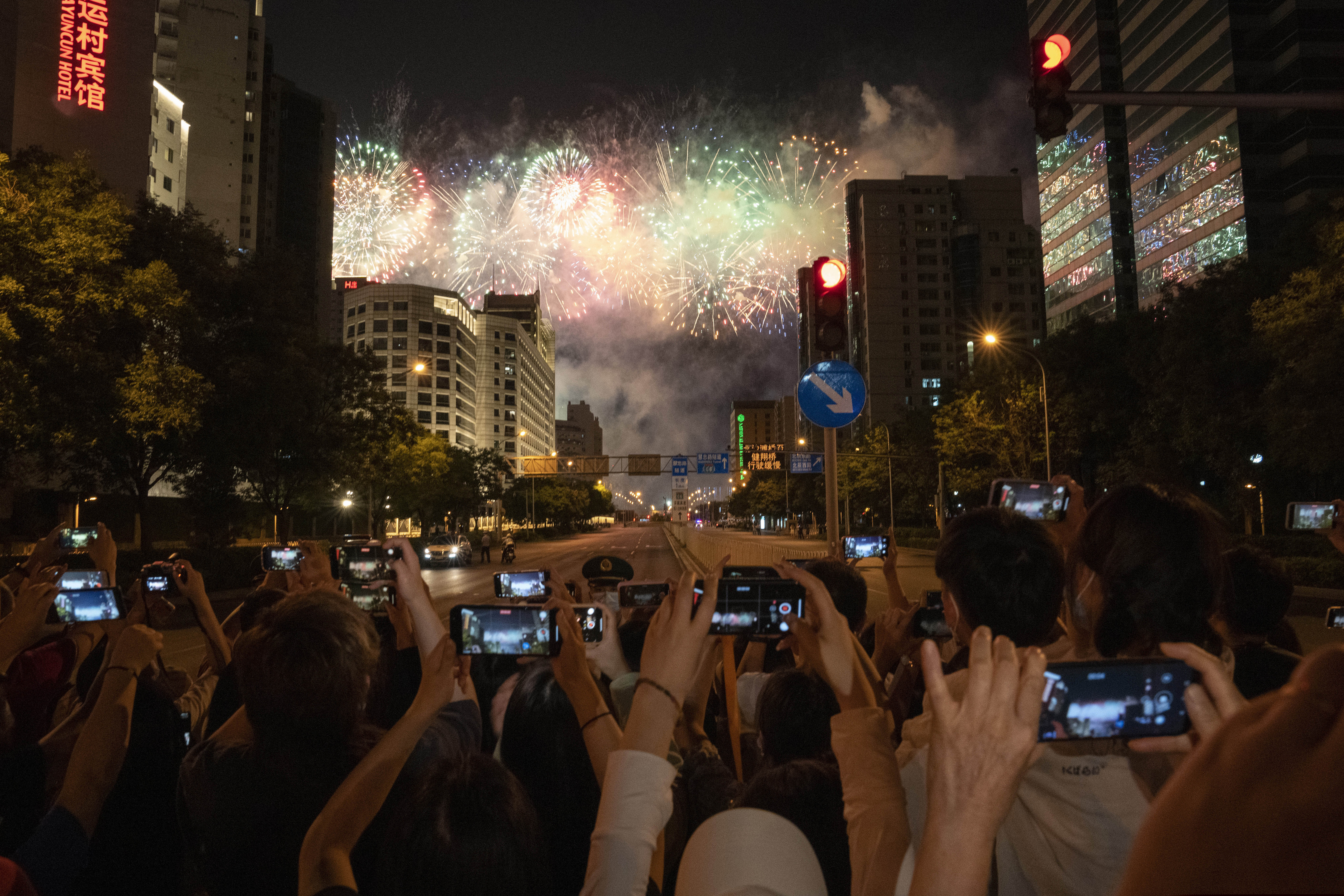 Residents gather to watch fireworks rehearsals on June 22 ahead of the 100th anniversary of the founding of China's ruling Communist Party in Beijing. Chinese authorities have closed Beijing's central Tiananmen Square to the public, eight days ahead of the major celebration.