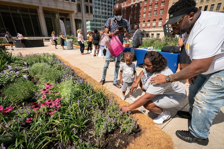Kim Robinson-Presley (second from right); her husband, Michael Presley; and her grandson Kyeyere Robinson (third from right), the son of her daughter Kimera Robinson, who died, at the opening of a memorial garden for overdose victims in Philadelphia on Aug. 31.