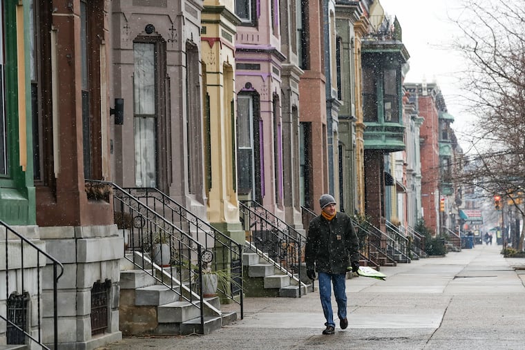 Pedestrians walk down Broad street and Reed as snow falls in Philadelphia on Friday, Jan. 28, 2022. Even a 15-minute walk can help boost your longevity.