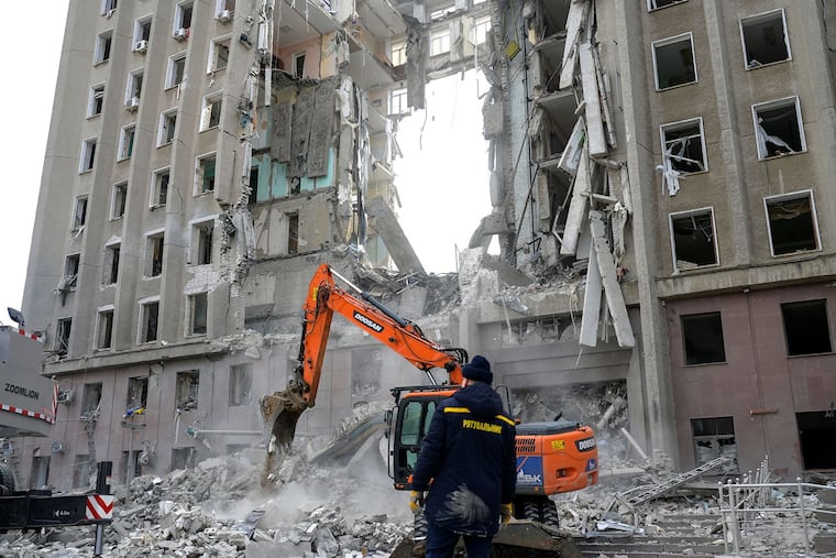 A worker watches an excavator clearing the rubble of a government building hit by Russian rockets in Mykolaiv, Ukraine, on March 29, 2022. Yevhen Zolotarov, CEO of the Ukrainian esports organization Natus Vincere, is so upset that he won't work with anyone who lives in Russia and pays taxes to the Russian Federation. (Bulent Kilic/AFP via Getty Images/TNS)