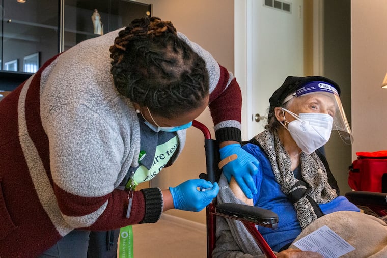 One of Philadelphia's oldest living residents, Ruth Hopson, 108, received the first of two dose Pfizer COVID-19 vaccine at her home in the River Park House, Conshohocken Avenue, Philadelphia on Friday afternoon, March 19, 2021. Her daughters Merle Hopson and Carla Hopson-Tyson were vaccinated also. (not shown) Administering vaccine is Joanah Fertil, Medical Assistant with Oak Street Health.