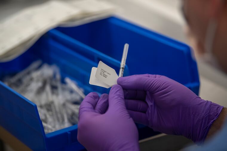 Michael Stepenaskie prepares a syringe at the Delaware County/Penn Health vaccination site in Radnor last month.