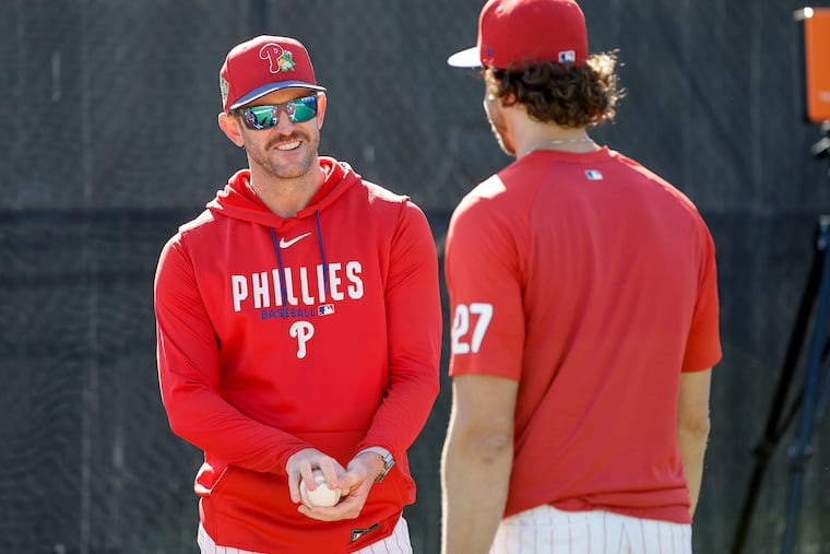 Phillies pitching coach Caleb Cotham (left) working with Aaron Nola during spring training.