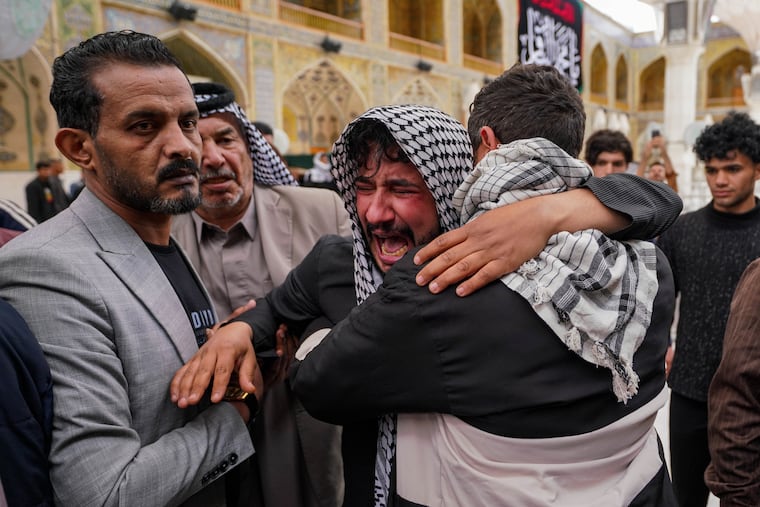 Relatives grieve an Iraqi soldier killed in a strike Wednesday on a military clinic in western Iraq's Anbar province, during a mass procession inside the shrine of Imam Ali in Najaf, Iraq, Thursday, March 26, 2026.