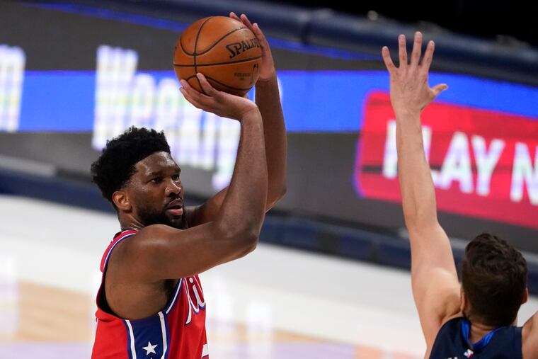 Philadelphia 76ers center Joel Embiid (21) takes a shot over Dallas Mavericks forward Maxi Kleber, right, in the second half of Monday's game in Dallas.