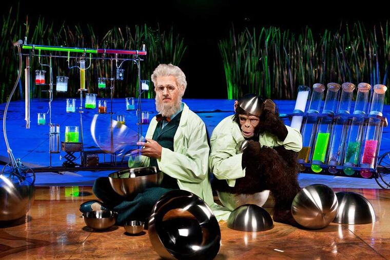 Philadelphia's Greg Kennedy plays a Darwinesque scientist working with a monkey lab assistant in his juggling act for Cirque du Soleil's "Totem," which will open at the Camden Waterfront on Thursday. (FRANCOIC-LACASSE)