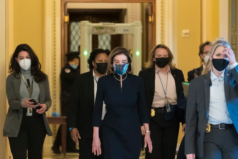 Speaker of the House Nancy Pelosi, D-Calif., returns to her leadership office after opening debate on the impeachment of President Donald Trump, at the Capitol in Washington, Wednesday, Jan. 13, 2021, The House of Representatives is pursuing an article of impeachment against Trump for his role in inciting an angry mob to storm the Capitol last week.