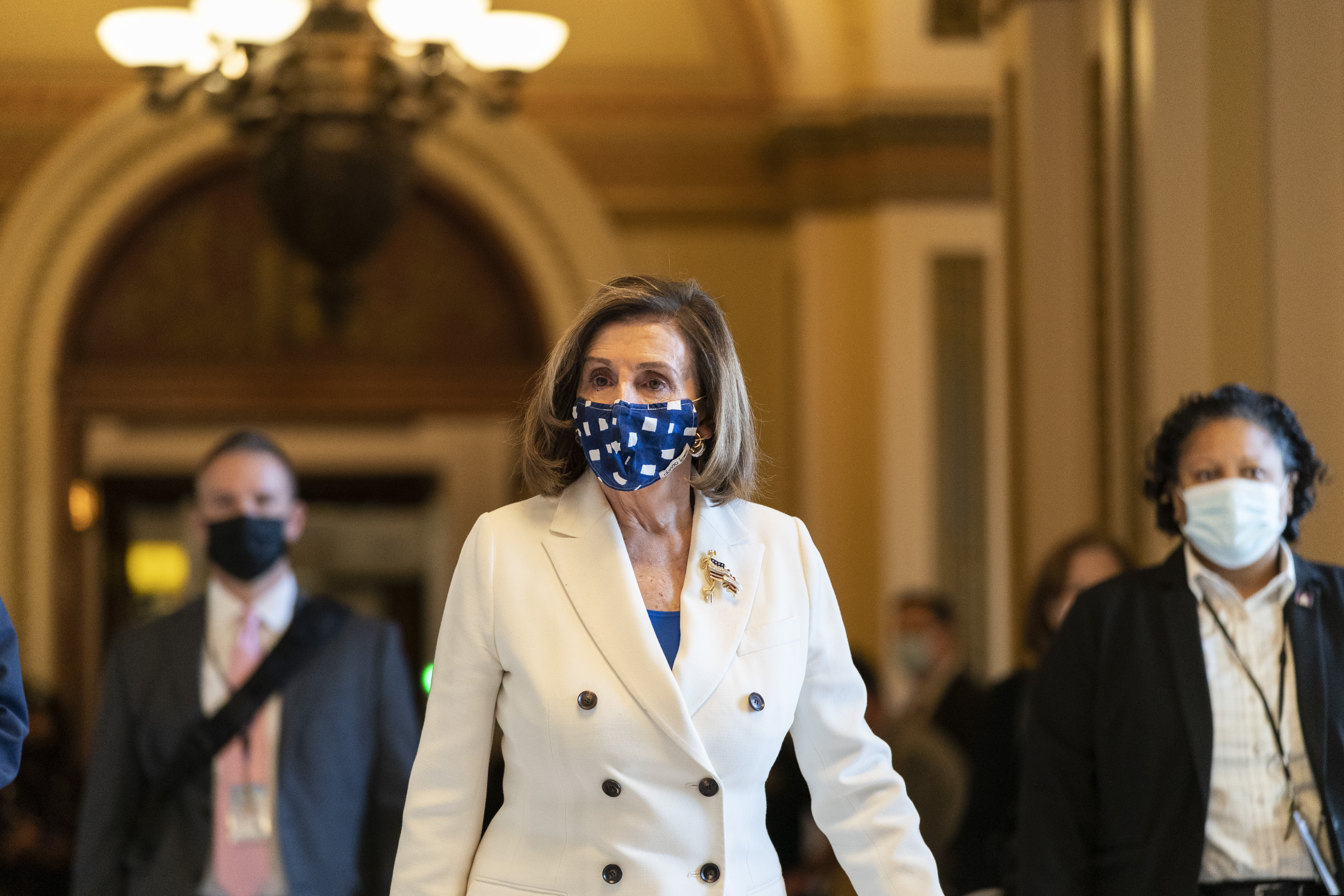 House Speaker Nancy Pelosi of Calif., walks from the House floor, during the vote on the Democrat's $1.9 trillion COVID-19 relief bill, on Capitol Hill on March 10.