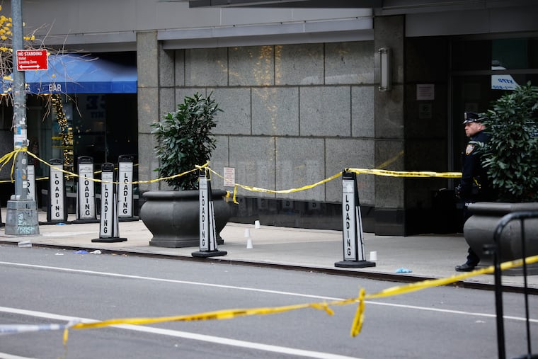A New York police officer stands outside the Hilton Hotel in midtown Manhattan where Brian Thompson, the CEO of UnitedHealthcare, was fatally shot Dec. 4.