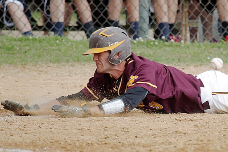 Fran Kinsey slides home. (Akira Suwa/Staff Photographer)