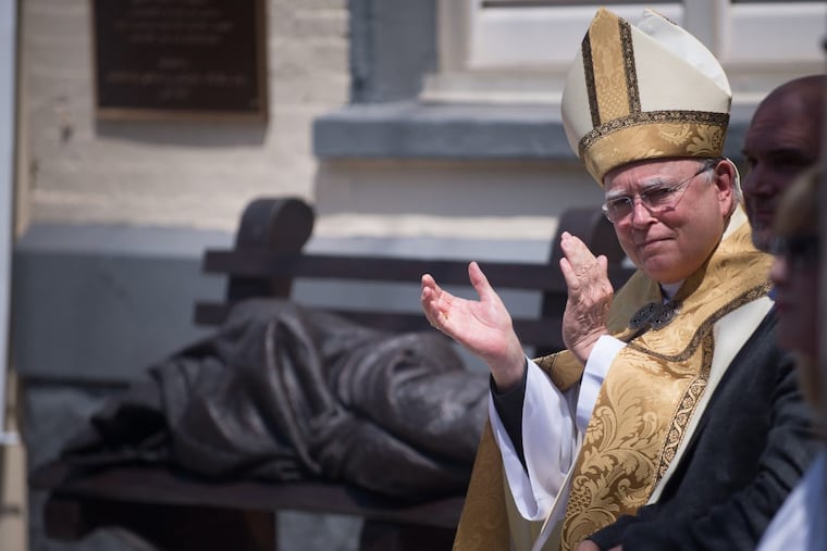 Archbishop Charles J. Chaput during the dedication of a “homeless Jesus” statue earlier this year.