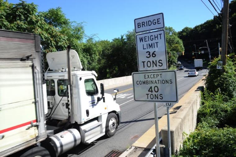 The Baltimore Avenue Bridge over Darby Creek, on the border of Lansdowne and Clifton Heights Boroughs, has a new weight restriction posted for heavy trucks. Due to the transportation budget impasse, PennDOT says about 130 bridges in suburban Philadelphia will now have weight restrictions posted, which will means miles-long detours for trucks. ( CLEM MURRAY / Staff Photographer )